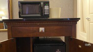 A compact kitchenette with a microwave, coffee maker, and mini-fridge. - Economy Lodge (Fiskdale)