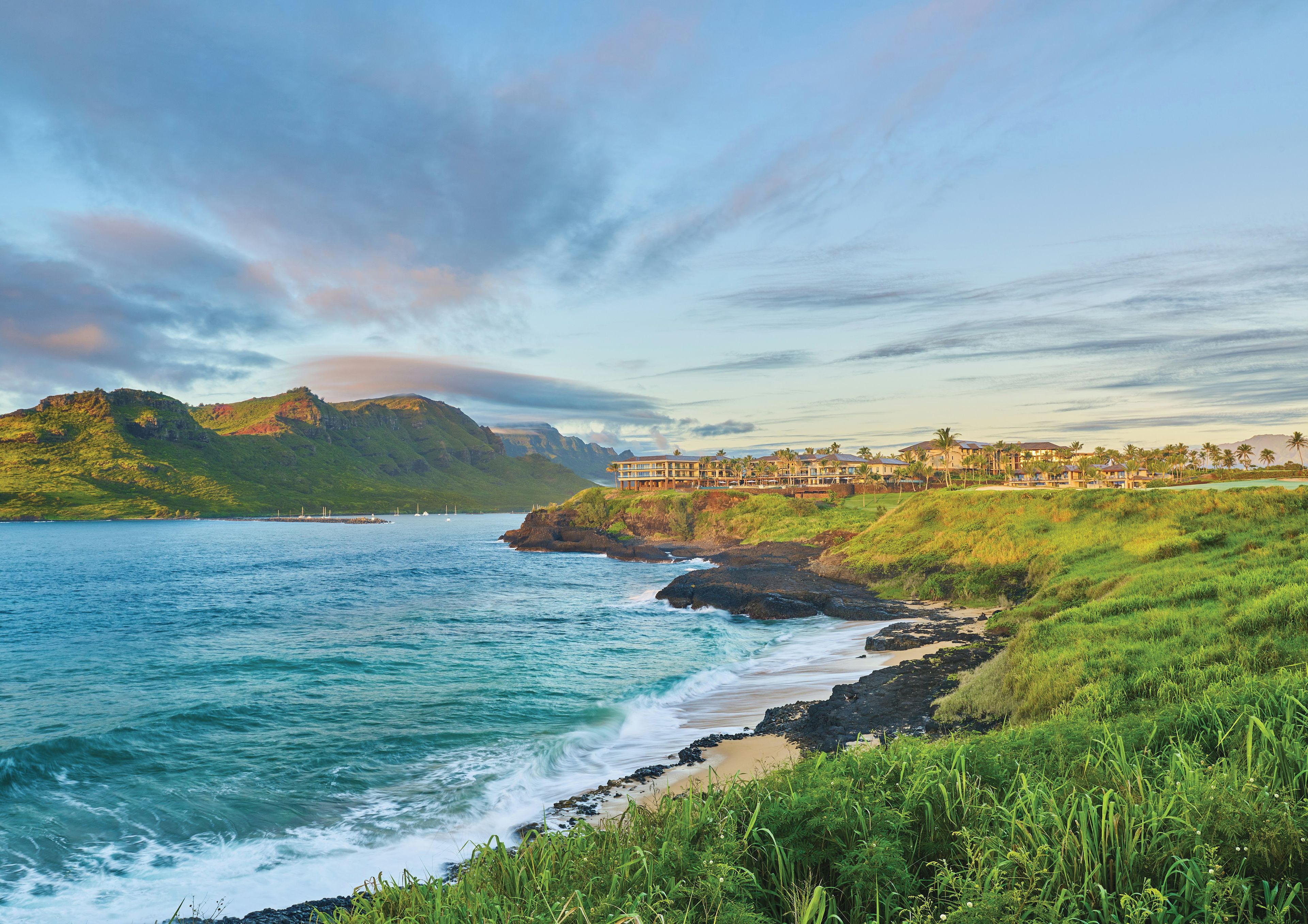 A coastal resort with a view of the ocean and mountains.