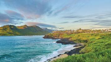 A coastal resort with a view of the ocean and mountains.