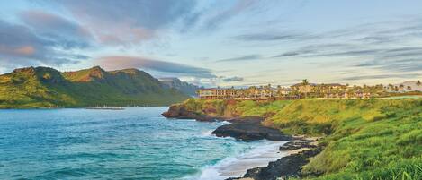 A coastal resort with a view of the ocean and mountains.