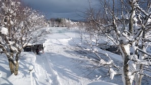 A snow-covered path with a snow blower and a fence in the background. - Pension Asangi (Hachimantai)