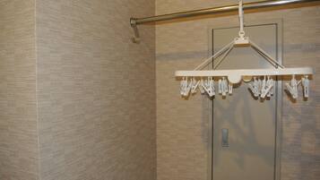 A shower area with a towel rack and a door.