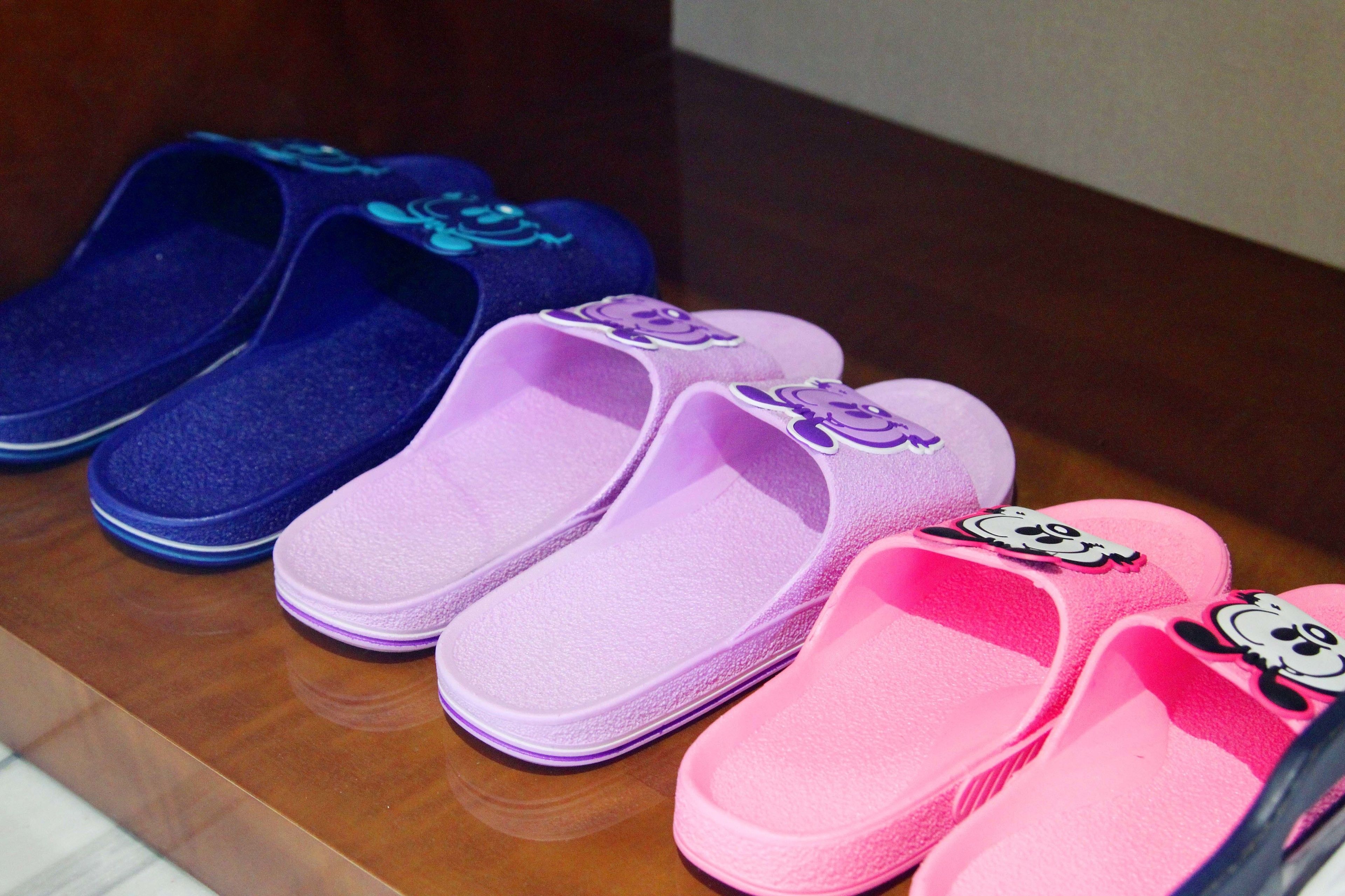 A pair of slippers with cartoon characters on them.
