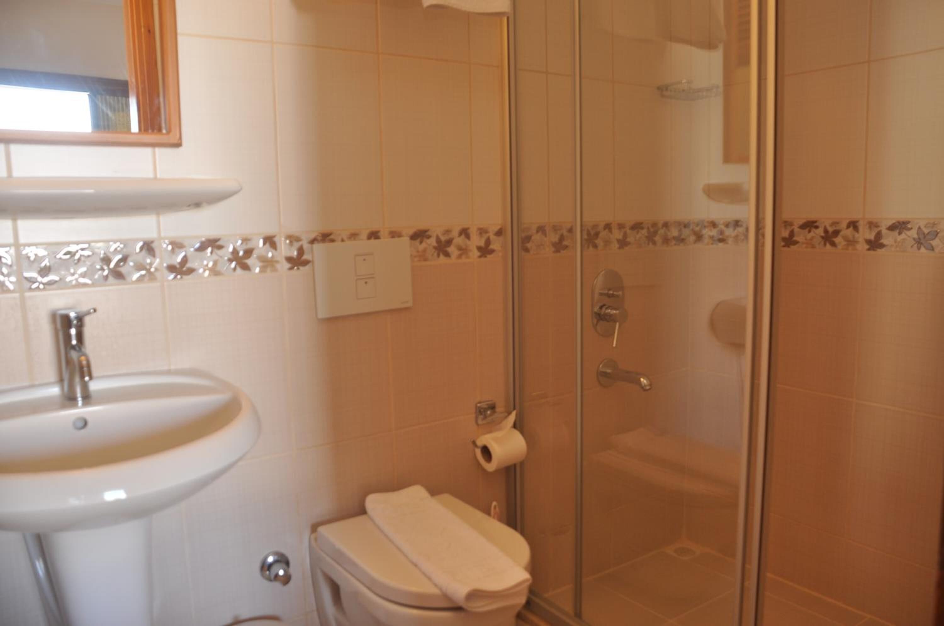 shower, hair dryer, slippers, towels