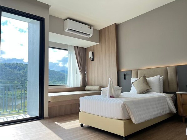 A modern bedroom with a large bed, a view of the outdoors, and an air conditioning unit. - Gassan Khuntan Golf and Resort (Mae Tha)