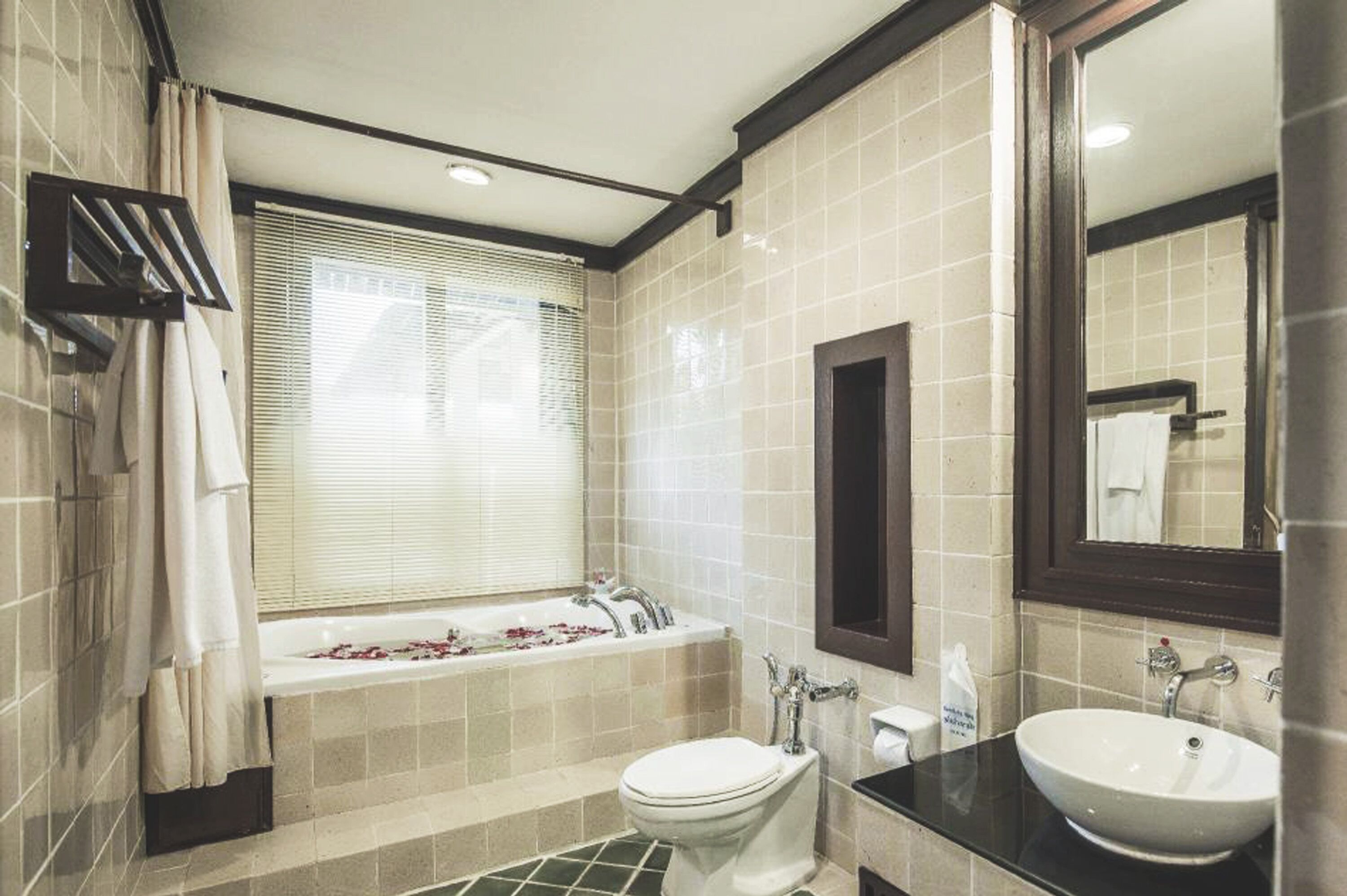 A bathroom with a bathtub, toilet, and sink.