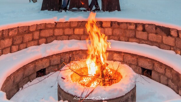 A building with multiple windows and a fire pit in the foreground. - The Kargil (Kargil)