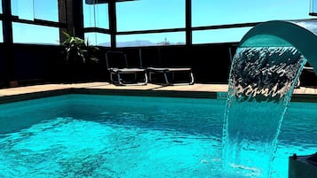 Seasonal outdoor pool, open 11:00 AM to 8:00 PM, pool umbrellas