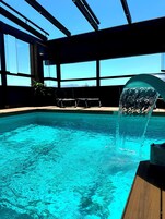 Seasonal outdoor pool, open 11:00 AM to 8:00 PM, pool umbrellas