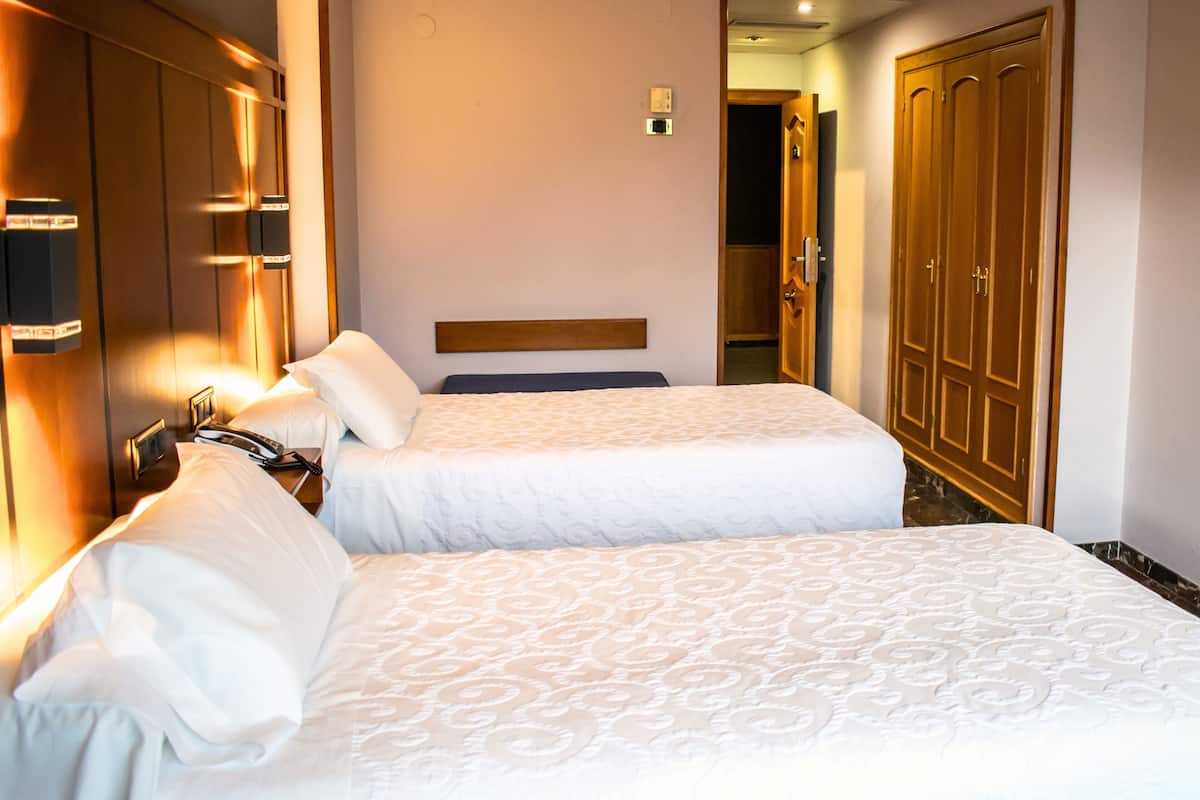 Double or Twin Room | 1 bedroom, in-room safe, desk, blackout drapes