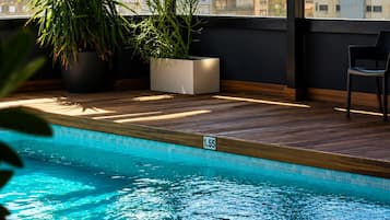 Indoor pool, open 11:00 AM to 8:00 PM, pool umbrellas, pool loungers