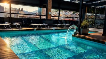 Indoor pool, open 11:00 AM to 8:00 PM, pool umbrellas, pool loungers