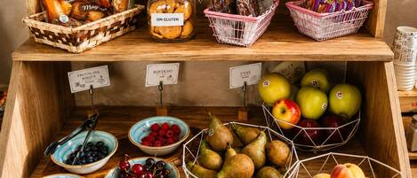A food display with various items including bread, biscuits, and fruits.