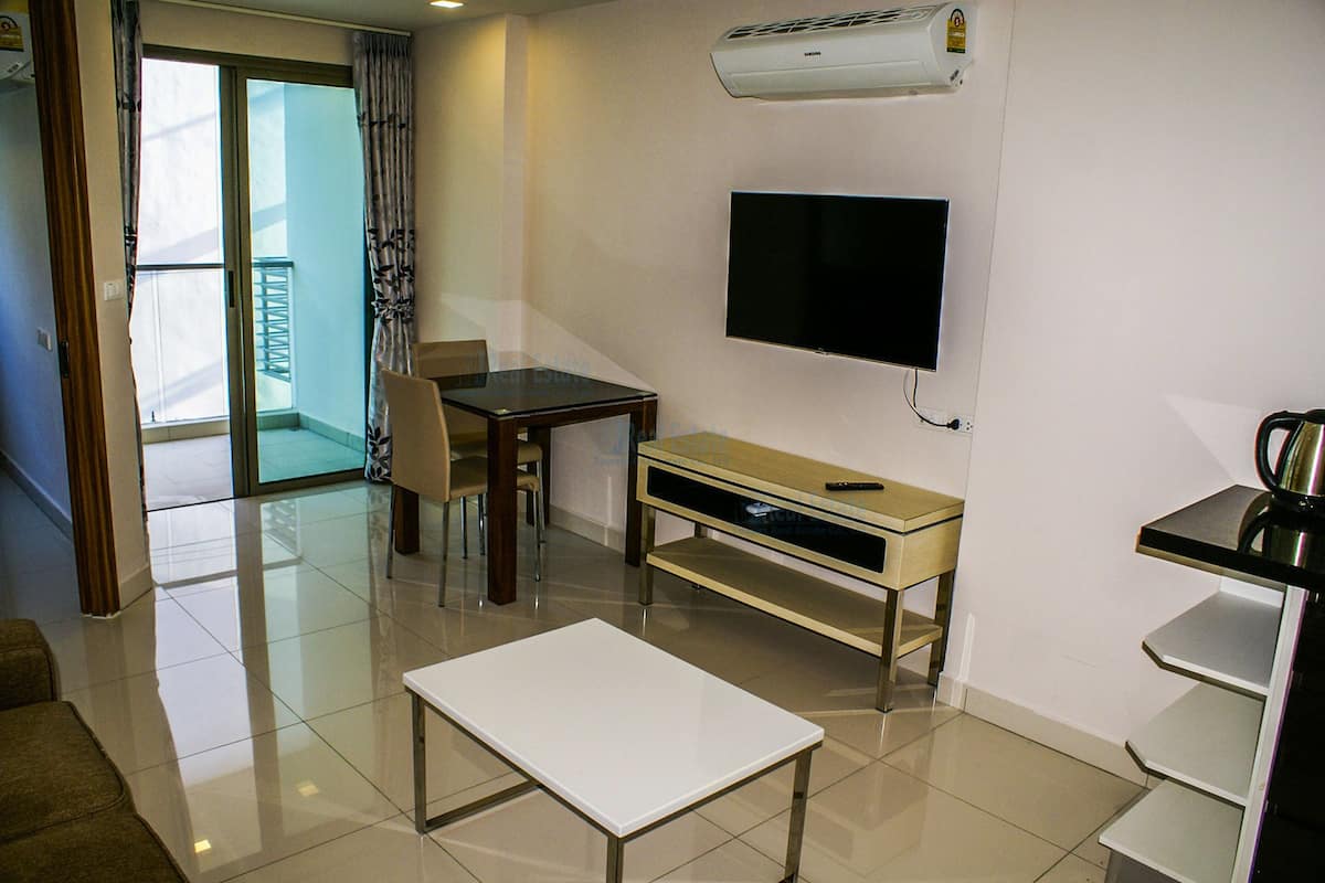 1-Bedroom Apartment | Living area | Flat-screen TV