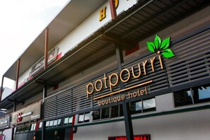 Un hôtel appelé « Potpourri Boutique Hotel », dont le logo est une feuille verte.