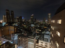 A nighttime cityscape with high-rise buildings and illuminated windows.