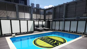 Seasonal outdoor pool, open 9:00 AM to 10:00 PM, pool loungers