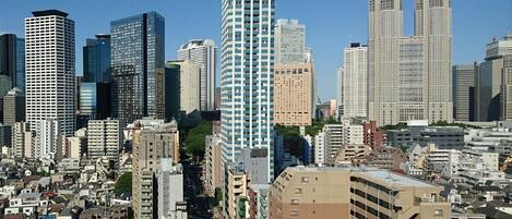 A cityscape with a variety of high-rise buildings, including a prominent cylindrical skyscraper and several rectangular high-rises.