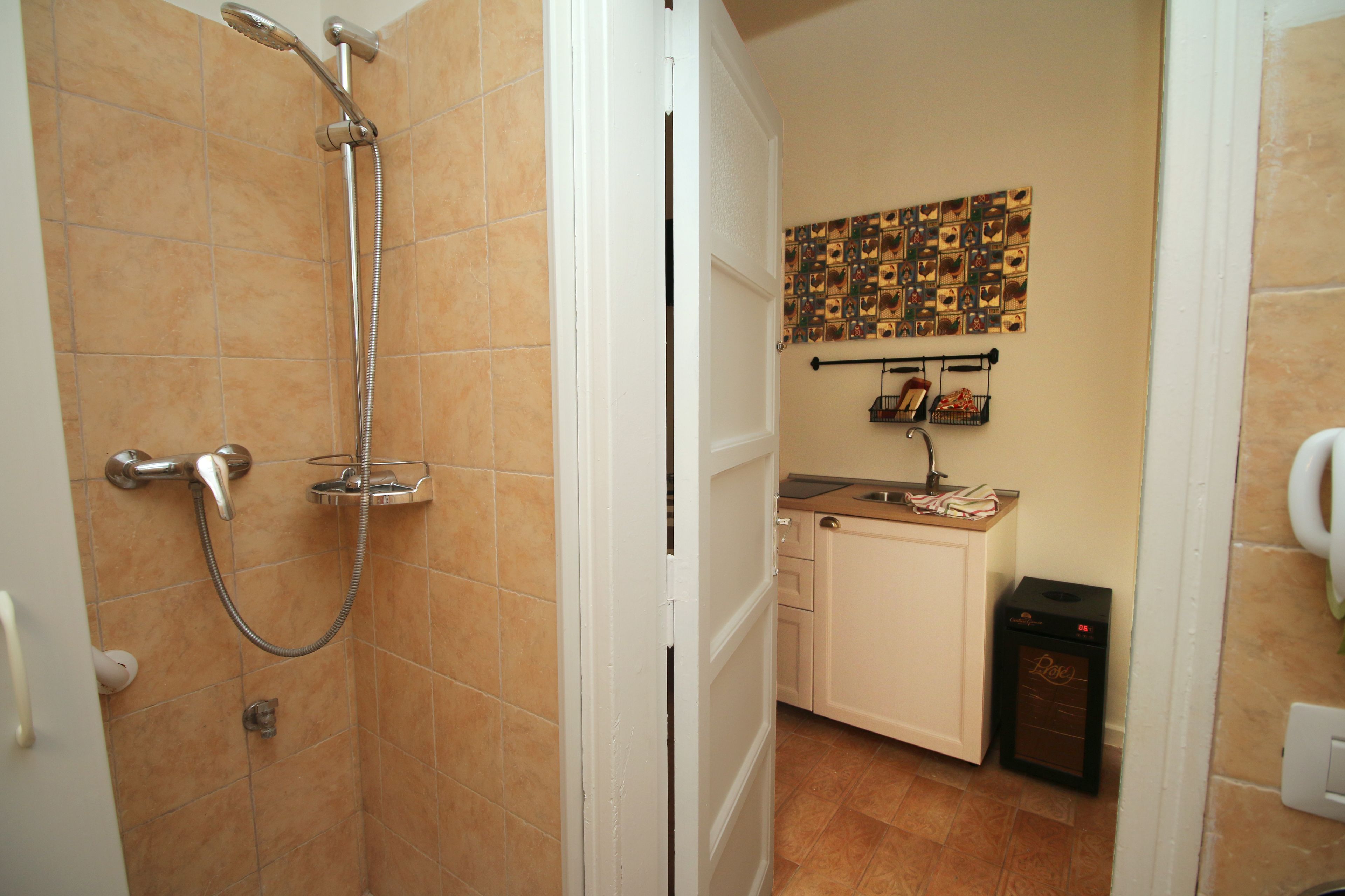 A bathroom with a shower, a toilet, and a sink.