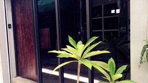 A building entrance with a wooden door and glass windows. - Inner Place (Tainan)