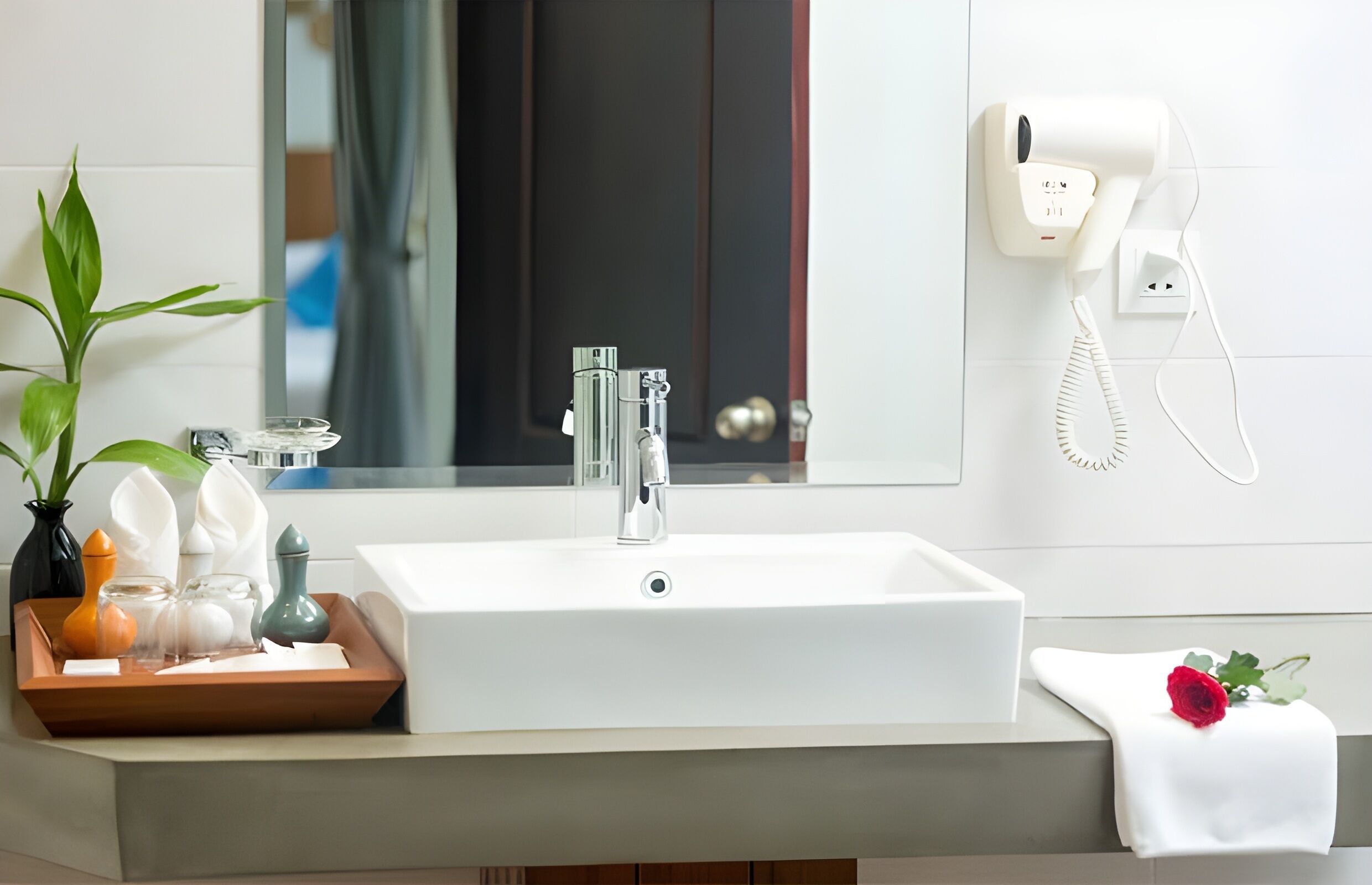 designer toiletries, hair dryer, slippers, towels