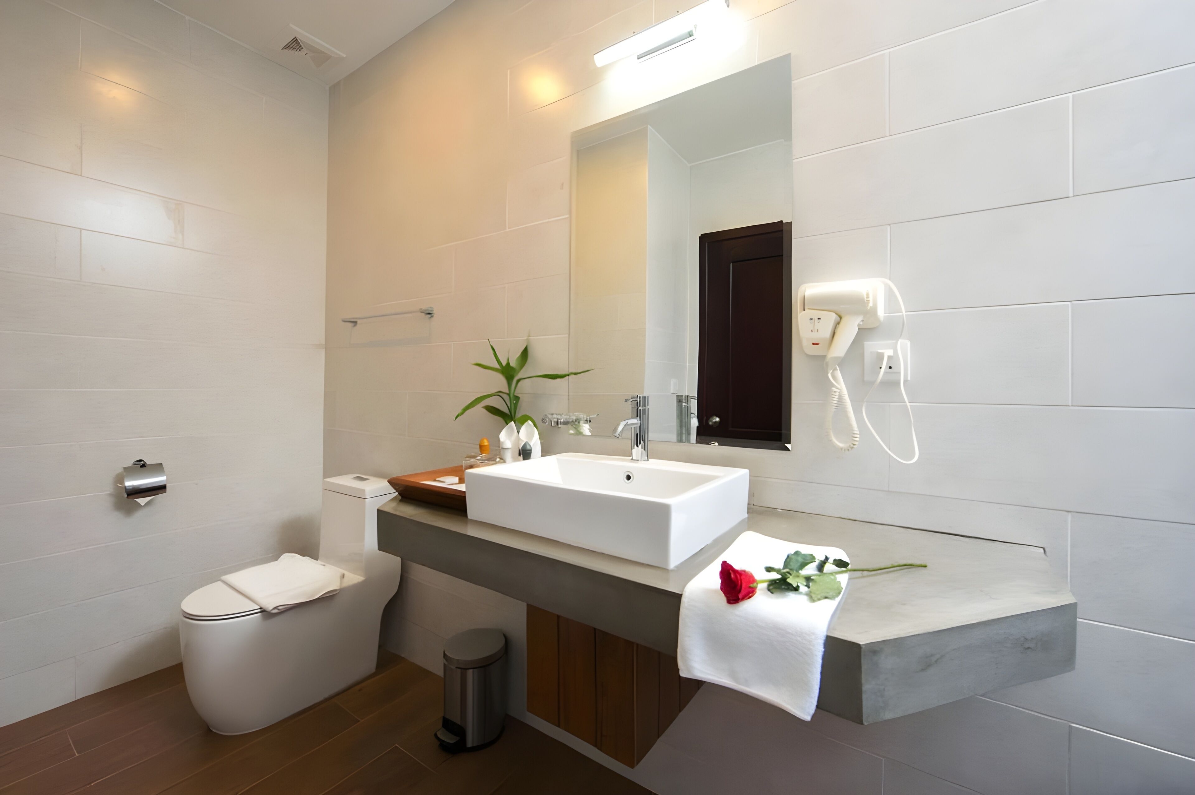 designer toiletries, hair dryer, slippers, towels