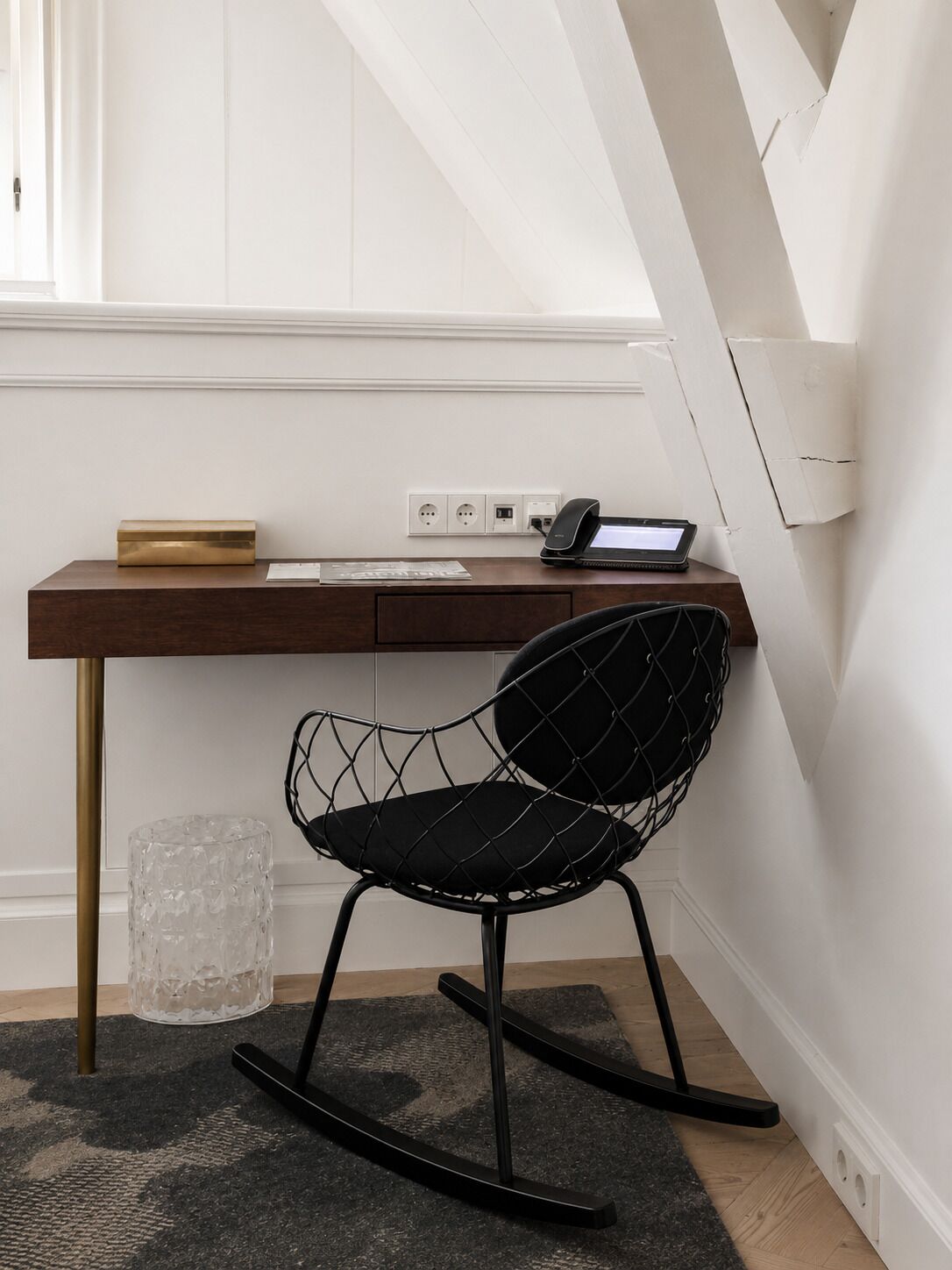A modern office space with a desk, chair, and computer.