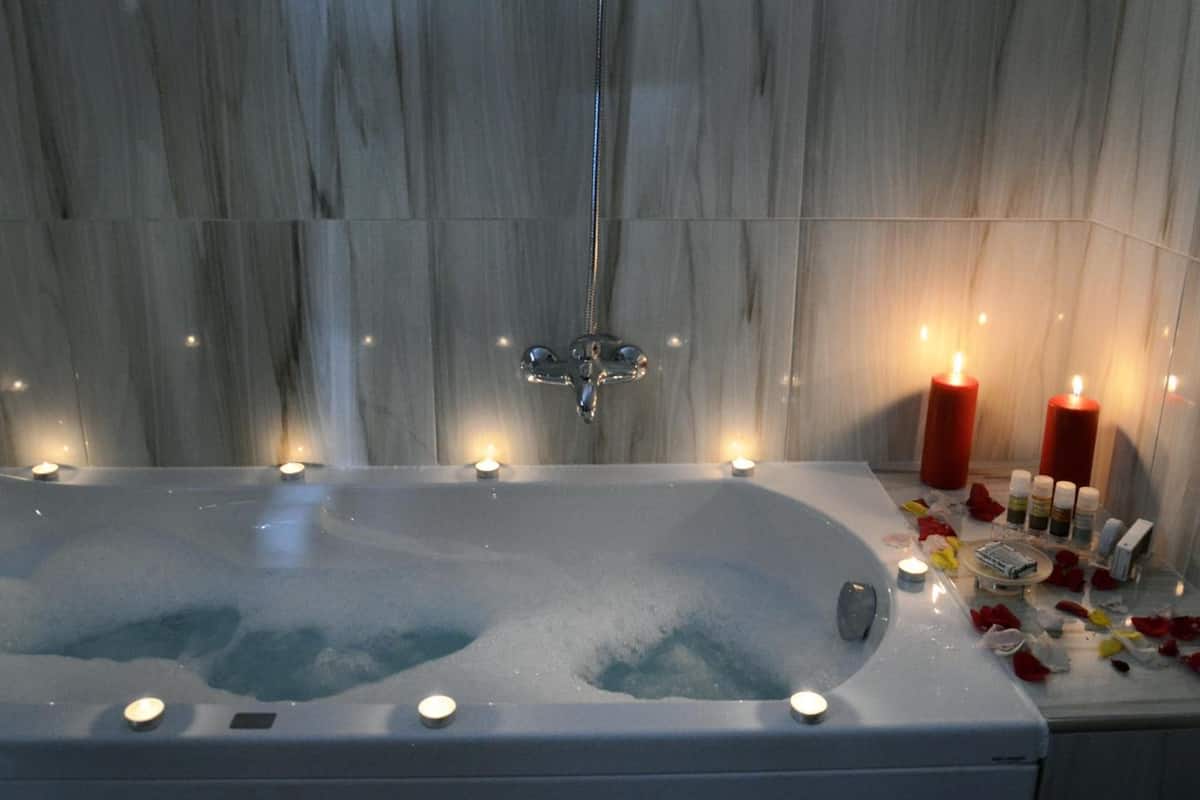 designer toiletries, hair dryer, slippers, towels