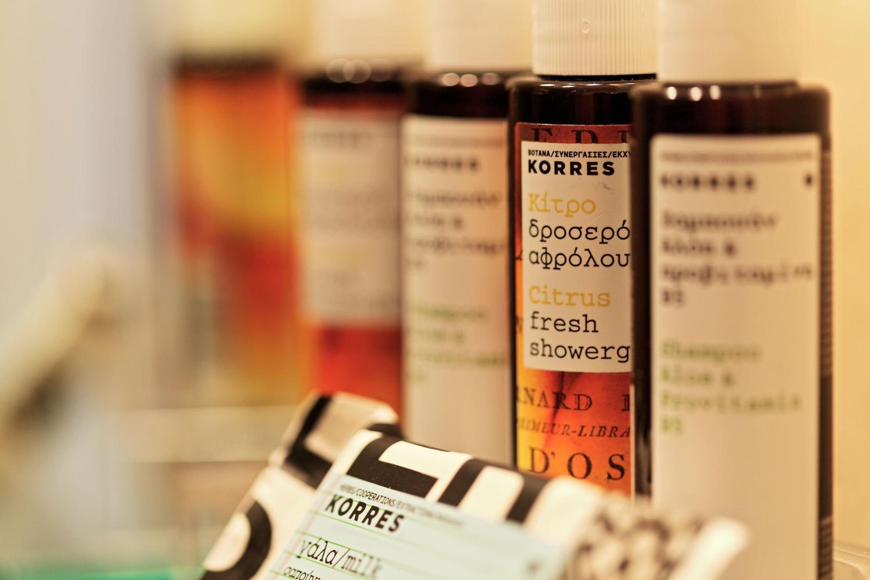 designer toiletries, hair dryer, slippers, towels