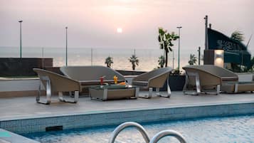 Outdoor pool, open 9:00 AM to 9:00 PM, pool loungers