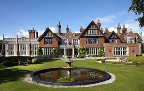 A large, historic building with a symmetrical facade, multiple chimneys, and a central entrance. - Macdonald Elmers Court Resort (Lymington)