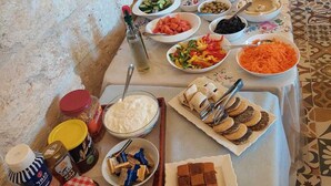 A buffet table with various food items and condiments. - Al Bishara Guest house (Nazareth)