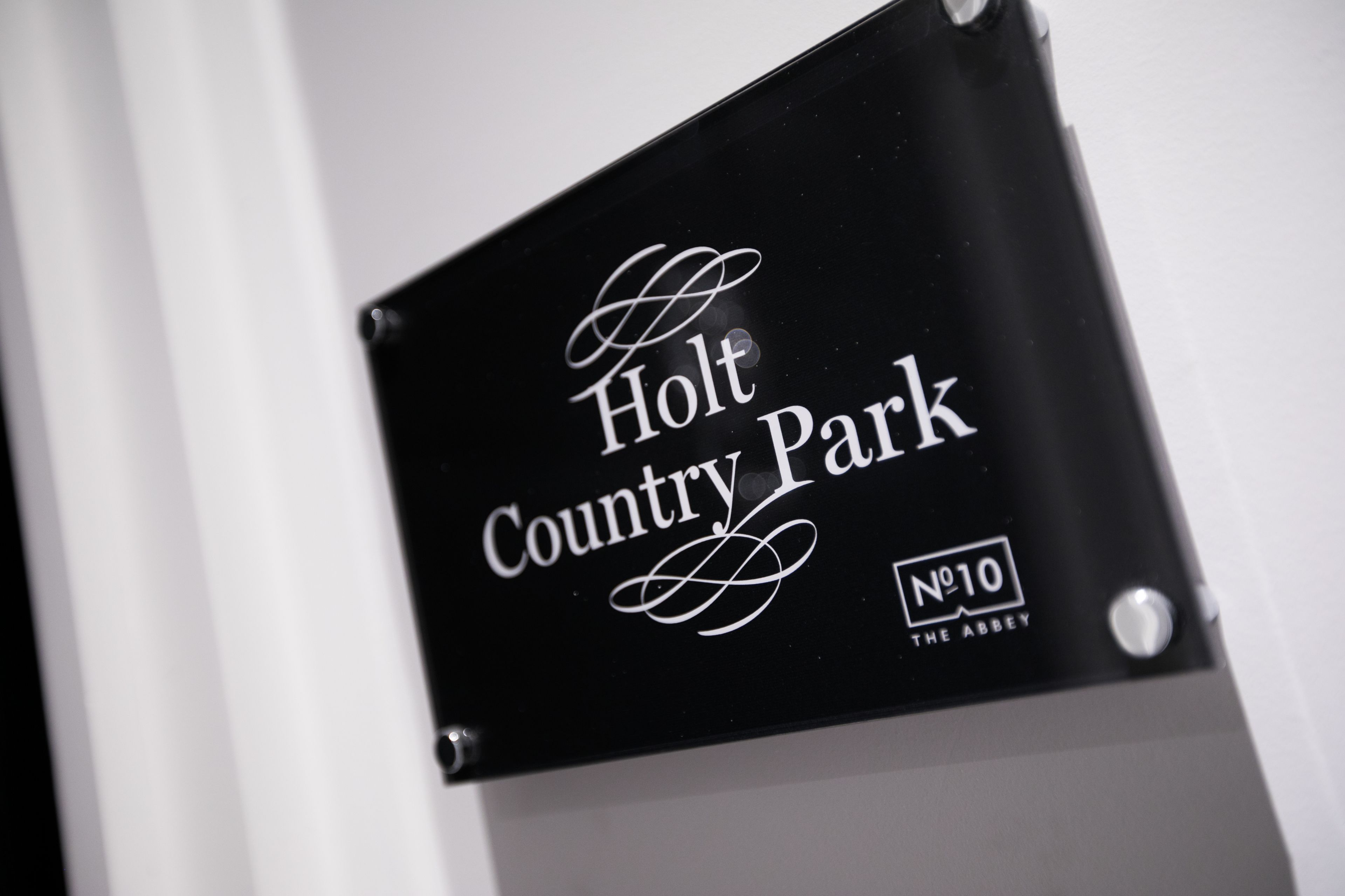 A sign for Holt Country Park.