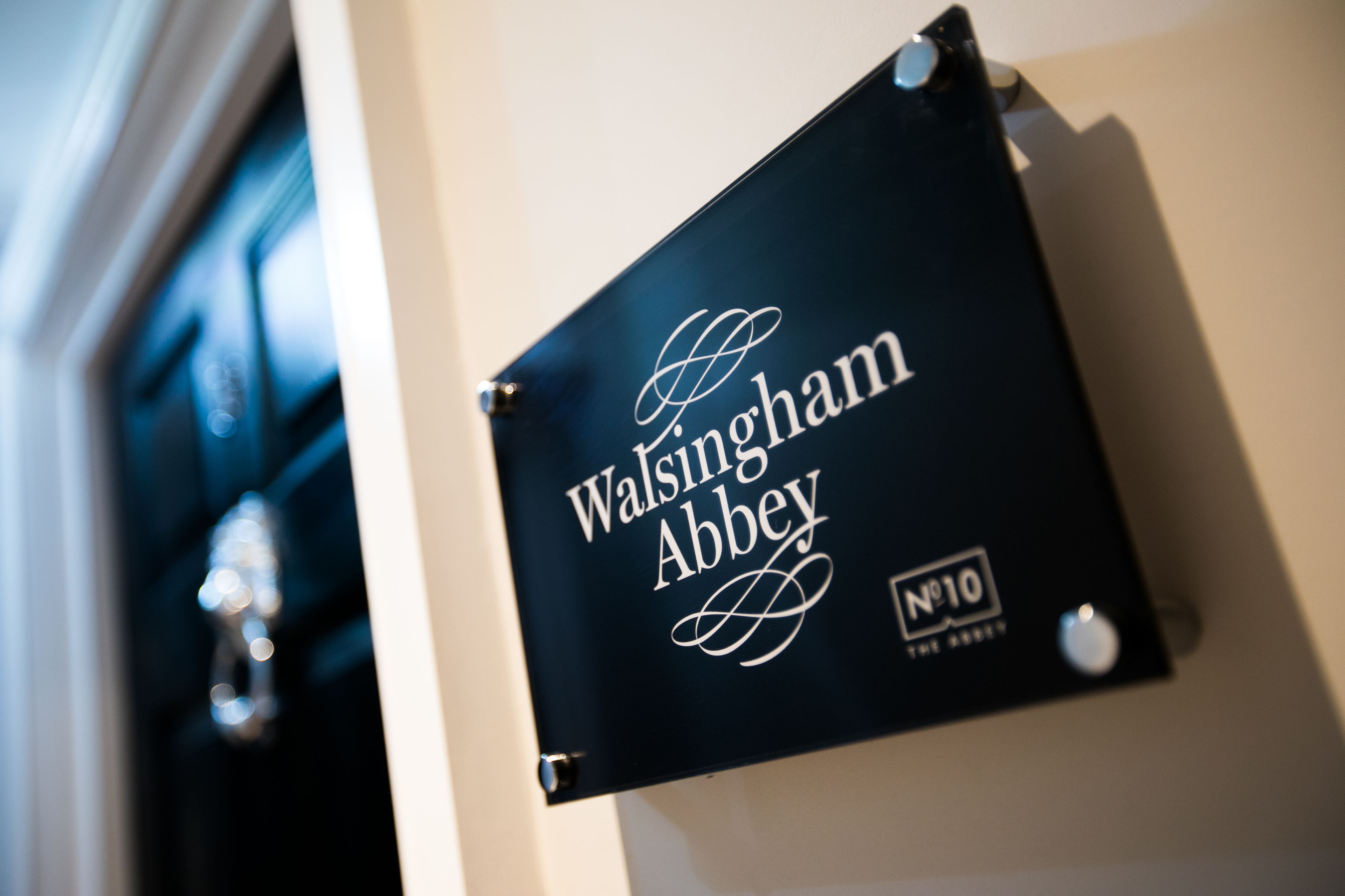 A sign with the text "Walsingham Abbey" and "N°10" indicating a specific location or room number.