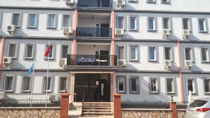 A multi-story building with a sign reading "Gizem Pensione". - Gizem Pansiyon (Çanakkale)