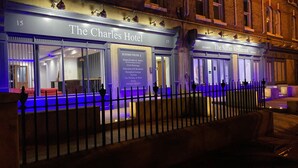 The Charles Hotel with a reception area, a terrace, and a sign listing amenities such as 24-hour portage, television, wifi, breakfast, and a reception lounge. - The Charles Hotel (Chatham)