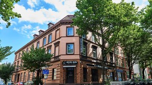 A two-story brick building with a sign for "Urban Home Hotel" and a "Hotel" sign above the entrance. - Urban Home Self Check-In Hotel (Hamburg)