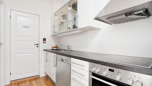 A compact kitchen with a stainless steel oven, a dishwasher, and a built-in microwave. - Modern Apartment In The City Center (Bergen)