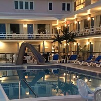 Una piscina al aire libre de temporada, sombrillas