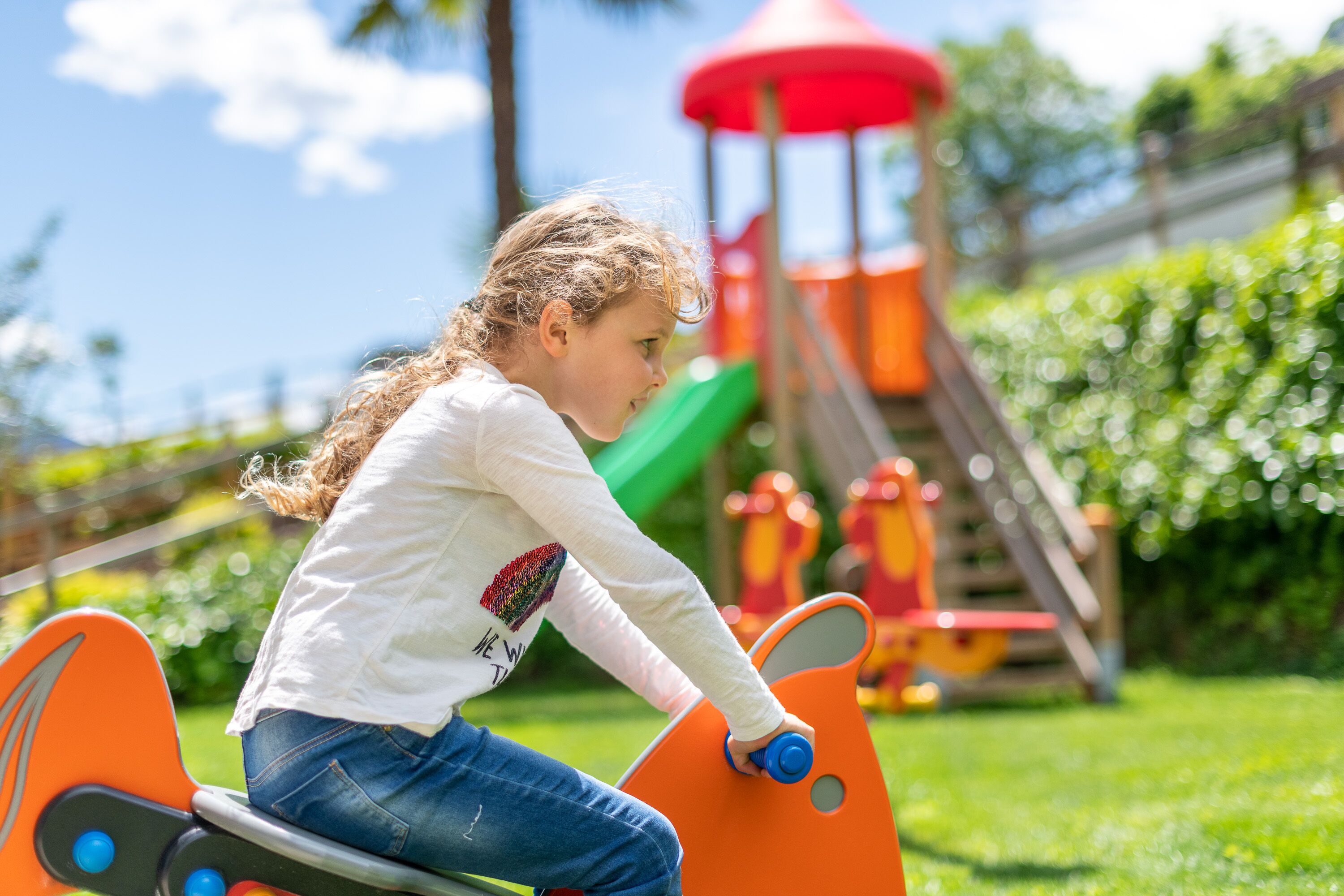 A child playing on a playground equipment in a park.