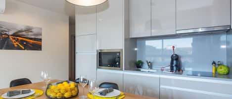 A modern kitchen with a dining area set for four.
