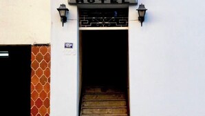 A hotel entrance with a sign reading "HOTEL TITO HOTEL" and a staircase leading inside. - Hotel Tito (Arequipa)