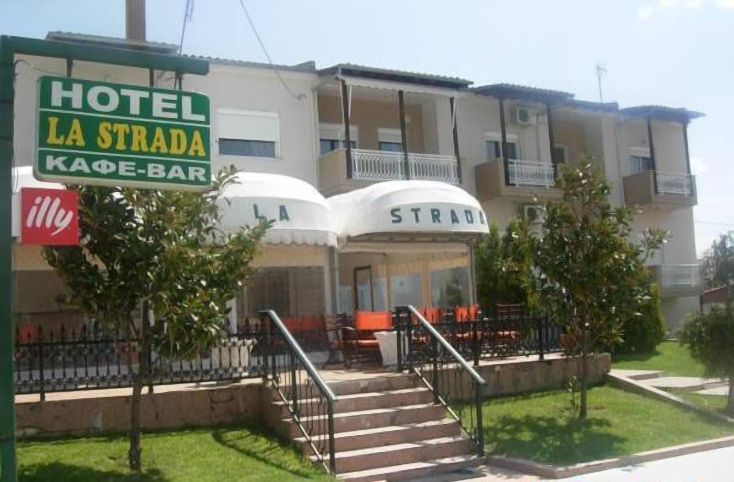 Hotel 'Hotel La Strada' met een café-bar, terras en een trap die naar de ingang leidt.