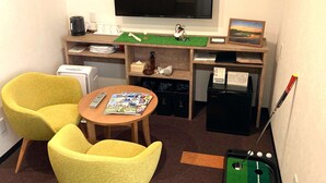 A hotel room with a TV, a small table with magazines, two yellow chairs, a mini fridge, a golf cart, and a painting on the wall. - Hotel Shin Osaka (Osaka)