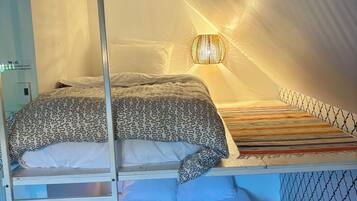 A bunk bed with a ladder, a wall-mounted light fixture, and a Wi-Fi sign.