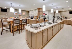 A modern kitchen with a central island, bar stools, and a breakfast bar. - Staybridge Suites Oklahoma City Dwtn - Bricktown by IHG (Oklahoma City)