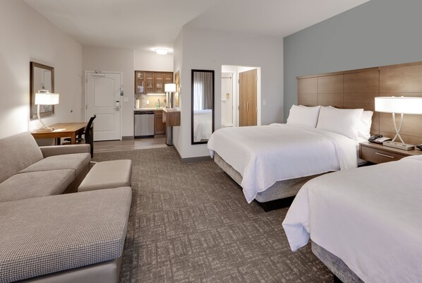 A hotel room with a large bed, a sofa, a desk, and a kitchenette. - Staybridge Suites Oklahoma City Dwtn - Bricktown by IHG (Oklahoma City)