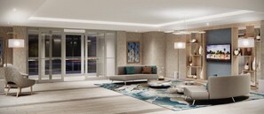 A modern living room with a sofa, armchairs, a coffee table, and a television.