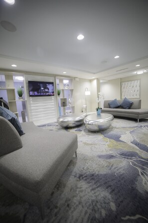 Relax in this inviting living space with a comfortable sofa, coffee table, and flat-screen TV.