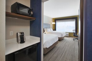 A hotel room with a microwave on a shelf, a coffee maker, two beds, a desk, and a chair. - Holiday Inn Express Auburn Hills South by IHG (Auburn Hills)
